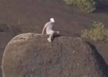 Tourists cause outrage after climbing volcanic bomb