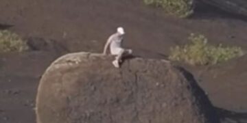 Tourists cause outrage after climbing volcanic bomb